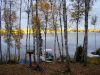 The setting sun casts a golden glow on the far shore illuminating the treeline.  A picture perfect end to a great day on the lake.