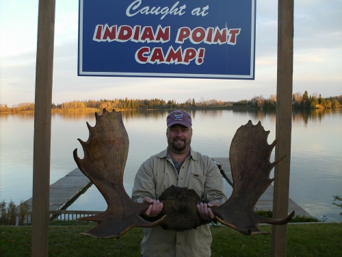 A guest holding up a nice moose rack! 