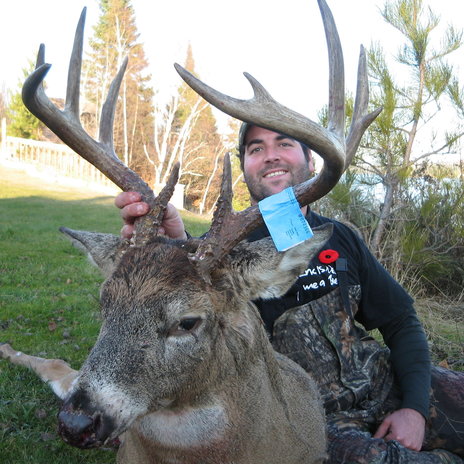 A hunter holding his nice buck! Just look at that rack. 