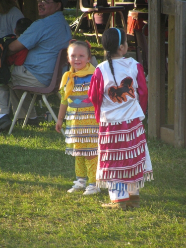 Two of the young participants at the Annual Pow Wow in Eagle River proudly show off their jingle dresses.